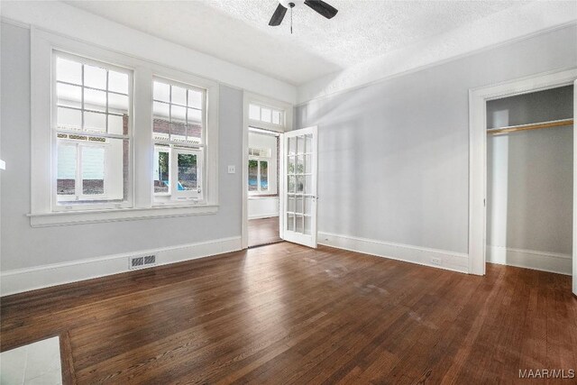 1427 S Court St, Montgomery, AL 36104 - unfurnished bedroom featuring wood finished floors, a textured ceiling, baseboards, and ceiling fan