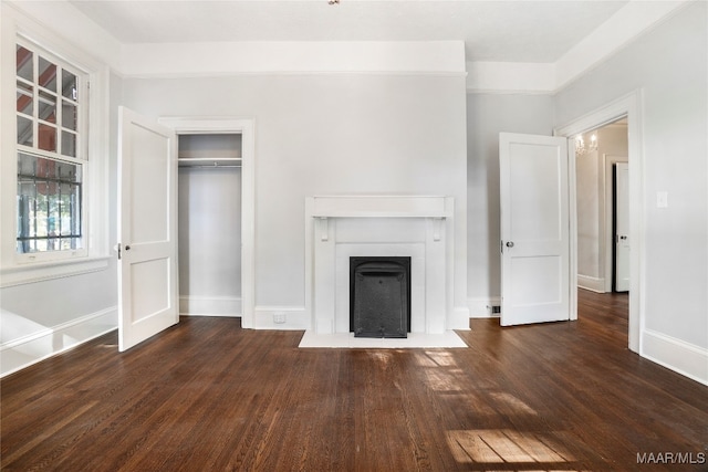 unfurnished living room with dark wood-type flooring