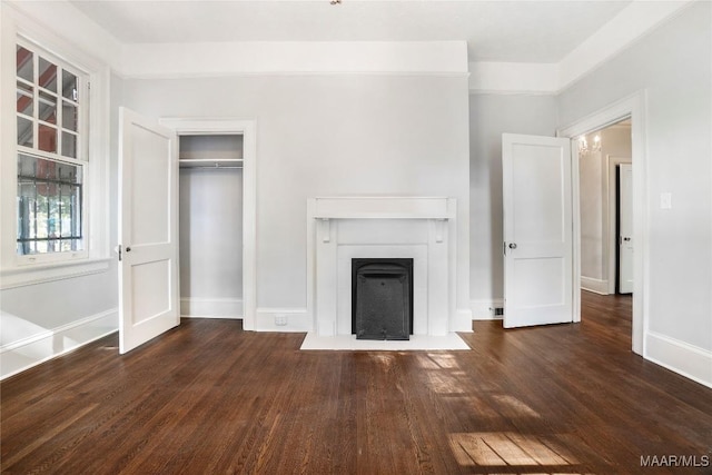 1427 S Court St, Montgomery, AL 36104 - unfurnished living room with wood finished floors, baseboards, and a fireplace with flush hearth