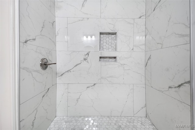 bathroom with a tile shower