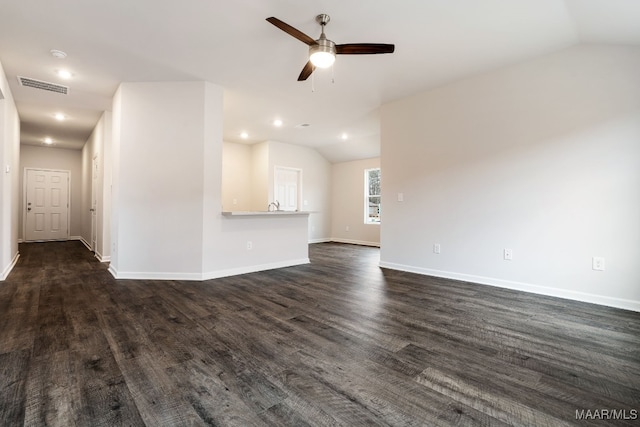 unfurnished living room featuring ceiling fan, dark hardwood / wood-style floors, and vaulted ceiling