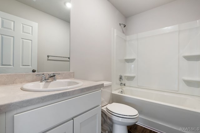 full bathroom with hardwood / wood-style floors, vanity, shower / bath combination, and toilet