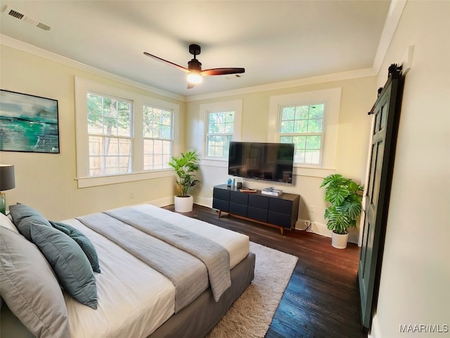 bedroom featuring ornamental molding, multiple windows, dark wood-type flooring, and ceiling fan