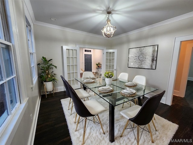 dining area featuring a chandelier, crown molding, french doors, and dark wood-type flooring