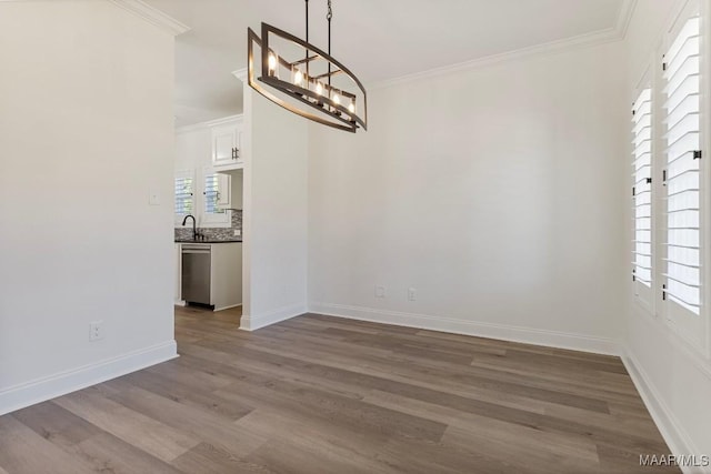 2524 Crenshaw Close Ct S, Montgomery, AL 36106 - unfurnished dining area featuring wood finished floors, ornamental molding, a chandelier, baseboards, and a sink