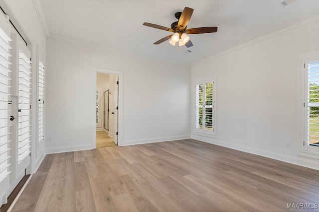 empty room with crown molding, ceiling fan, and light hardwood / wood-style floors