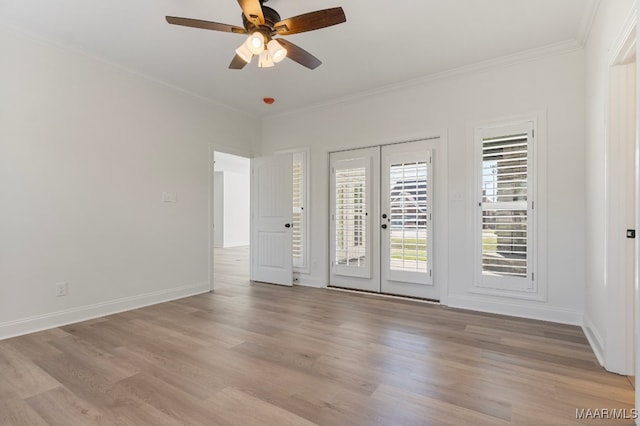 spare room featuring french doors, light hardwood / wood-style flooring, ceiling fan, and crown molding