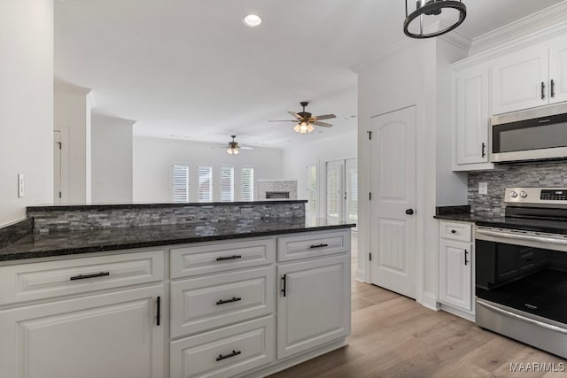 kitchen with decorative backsplash, stainless steel appliances, ceiling fan, light hardwood / wood-style floors, and white cabinetry