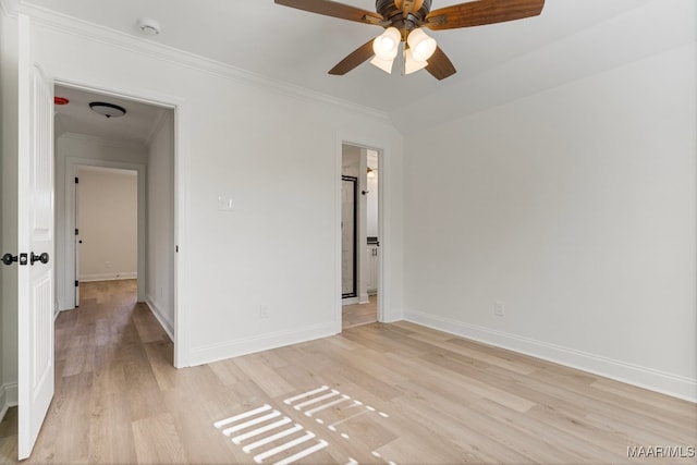 empty room with light hardwood / wood-style floors, ceiling fan, and crown molding