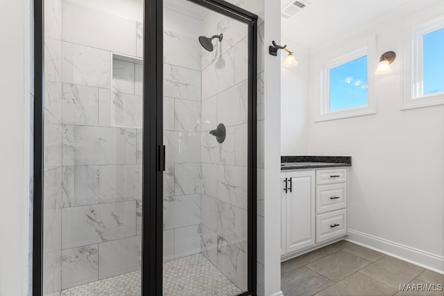 bathroom featuring vanity, tile patterned floors, and walk in shower