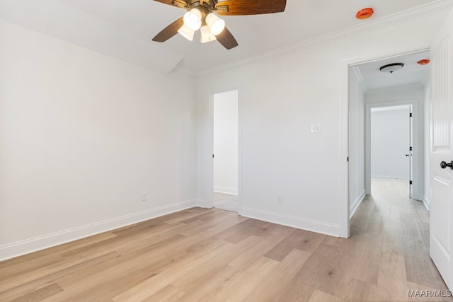 empty room featuring light hardwood / wood-style floors, ceiling fan, and crown molding