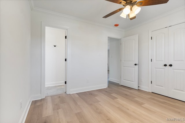 unfurnished bedroom featuring ceiling fan, light wood-type flooring, and crown molding