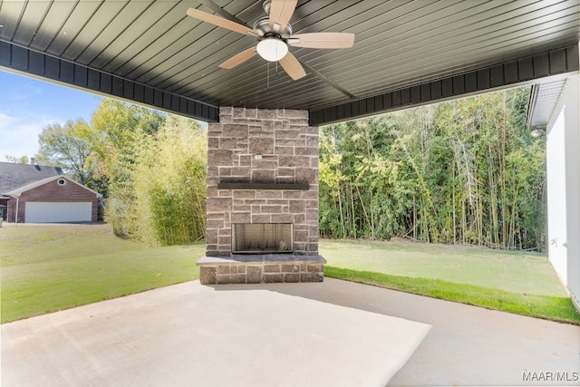 view of patio with an outdoor stone fireplace and ceiling fan