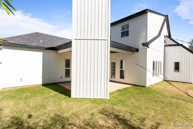 back of property with a patio area and a yard