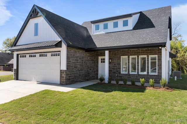 view of front of house with central AC, a front lawn, and a garage