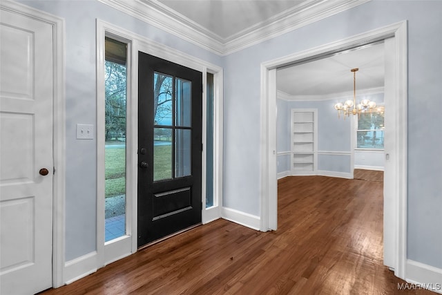 entryway with crown molding, a chandelier, dark hardwood / wood-style flooring, and a healthy amount of sunlight