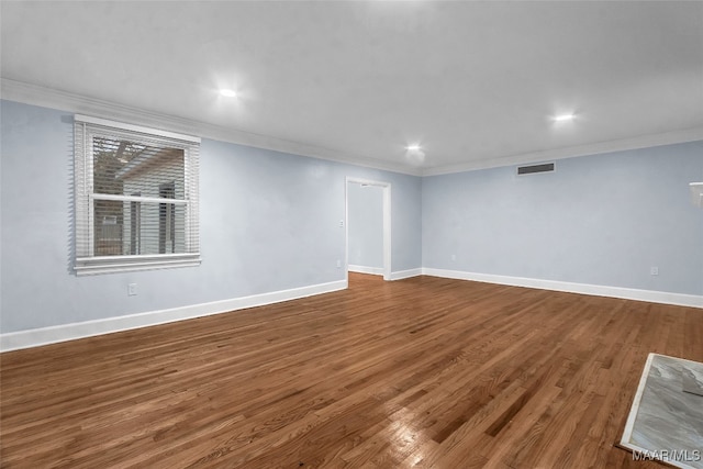 spare room featuring hardwood / wood-style floors and ornamental molding