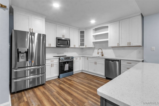 kitchen featuring stainless steel appliances, white cabinetry, dark hardwood / wood-style floors, and sink