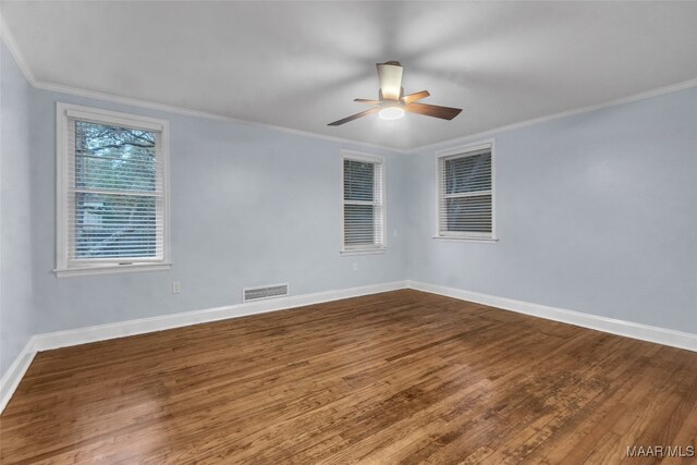 unfurnished room featuring hardwood / wood-style flooring, ceiling fan, and crown molding