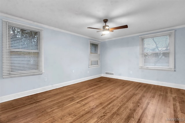 spare room with ceiling fan, wood-type flooring, and ornamental molding