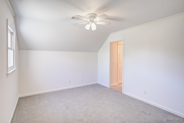 bonus room featuring vaulted ceiling, light carpet, and ceiling fan