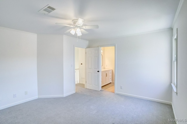 unfurnished room featuring crown molding, light colored carpet, and ceiling fan