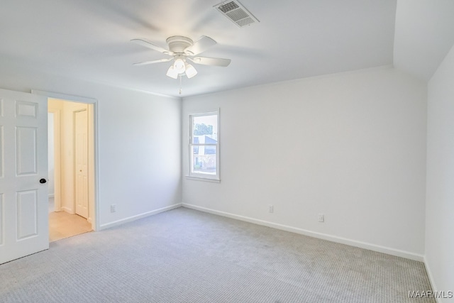 carpeted spare room featuring ceiling fan