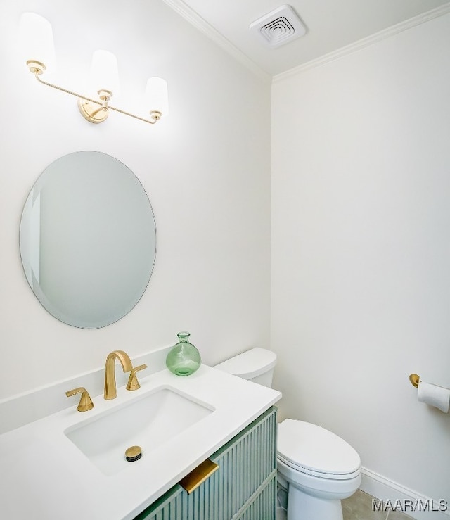 bathroom featuring vanity, ornamental molding, and toilet