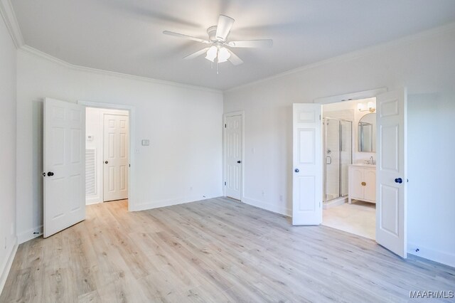 unfurnished bedroom with crown molding, ensuite bath, ceiling fan, and light wood-type flooring