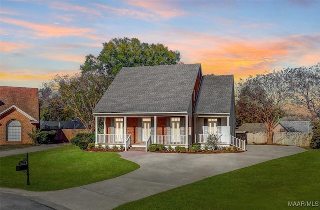 view of front of home featuring a yard and covered porch