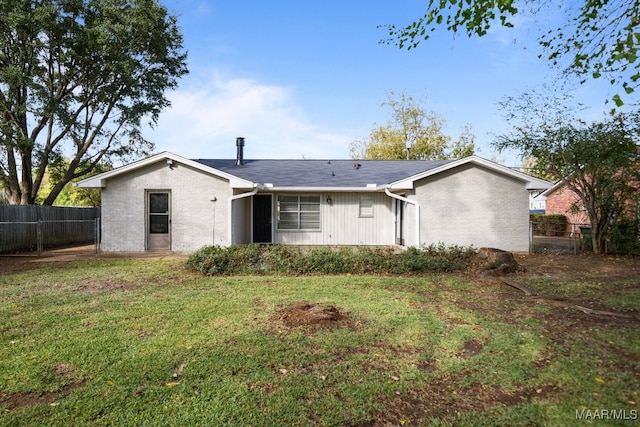 rear view of property with a yard