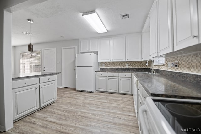 kitchen featuring white cabinetry, sink, white appliances, and light hardwood / wood-style flooring