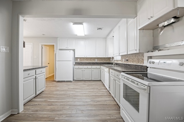 kitchen featuring white cabinets, light hardwood / wood-style floors, white appliances, and backsplash