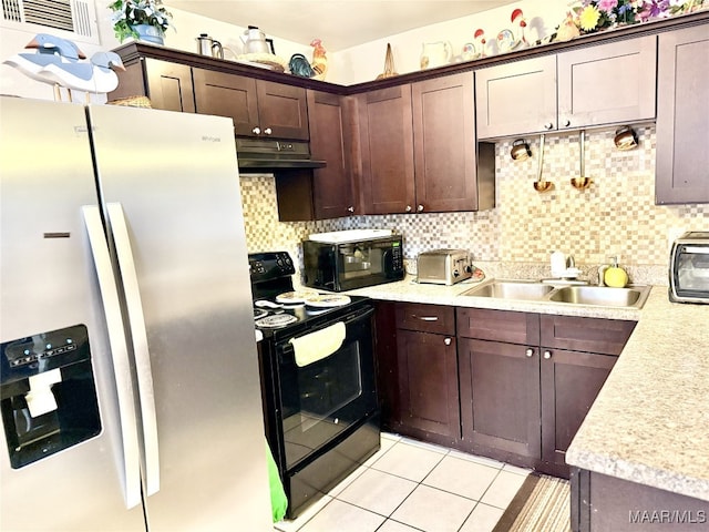 kitchen with backsplash, dark brown cabinetry, sink, black appliances, and light tile patterned floors