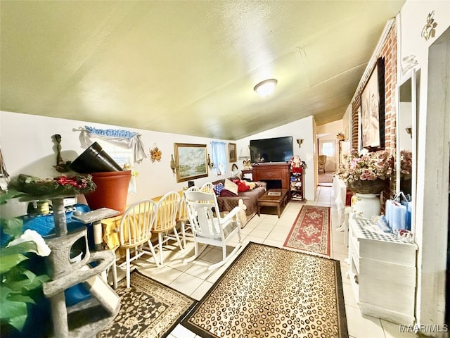 living room with lofted ceiling and light tile patterned floors