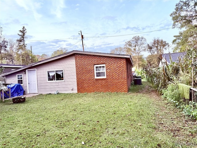 view of home's exterior featuring a yard and central AC unit