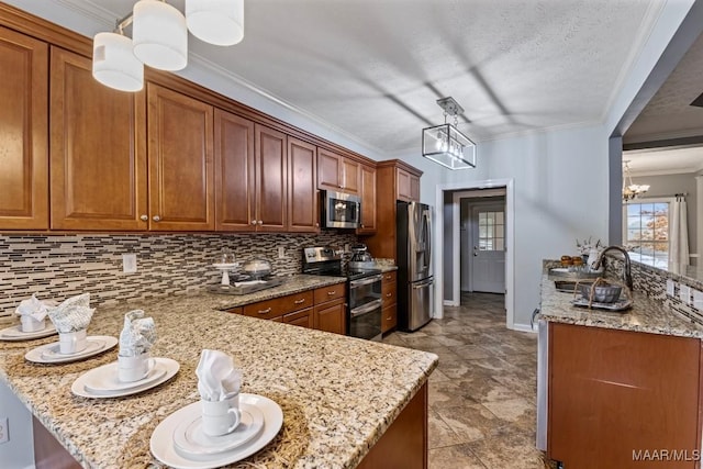 kitchen featuring kitchen peninsula, light stone countertops, stainless steel appliances, decorative light fixtures, and a chandelier