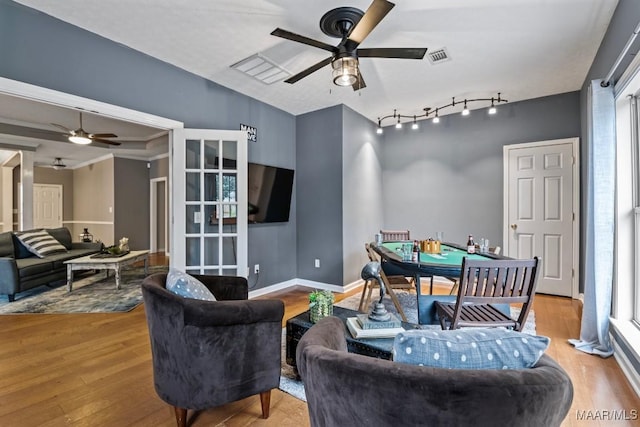 interior space with ceiling fan and light hardwood / wood-style floors