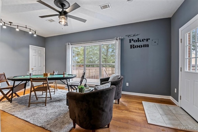 recreation room with ceiling fan and hardwood / wood-style floors