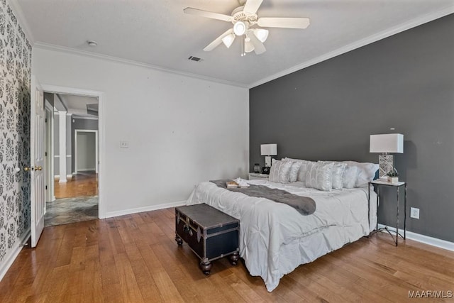 bedroom featuring wood-type flooring, ceiling fan, and ornamental molding