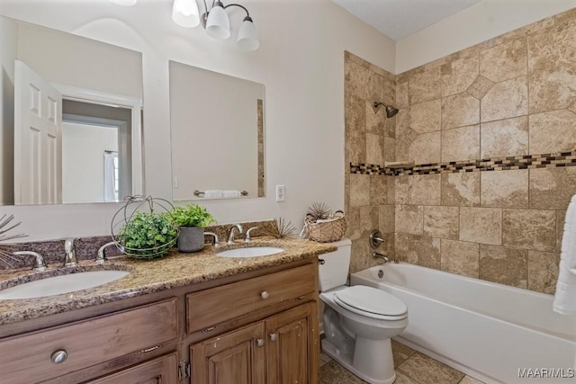 full bathroom featuring vanity, tile patterned floors, tiled shower / bath combo, and toilet