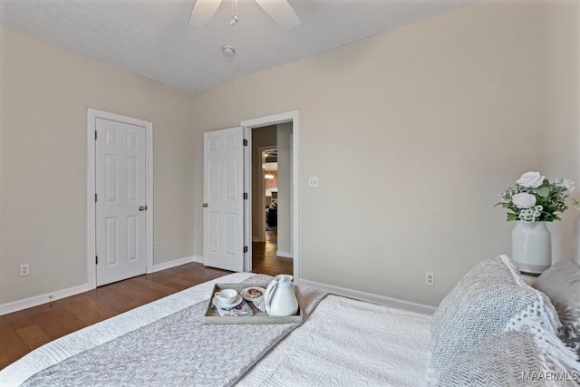 bedroom with dark hardwood / wood-style floors and ceiling fan