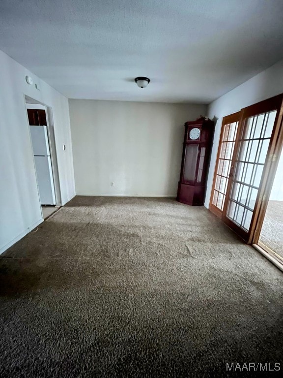 interior space featuring carpet floors and a textured ceiling