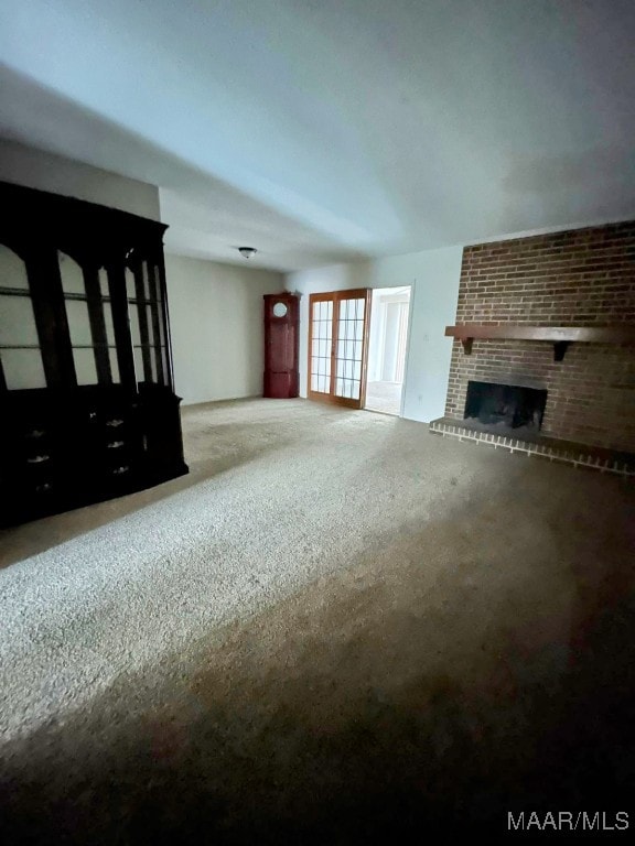 unfurnished living room featuring a brick fireplace