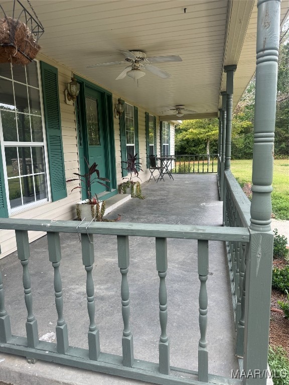 view of patio with ceiling fan and a porch