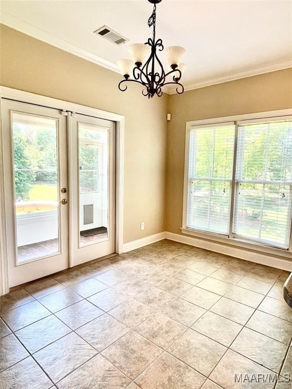 unfurnished dining area with french doors, light tile patterned floors, ornamental molding, and a notable chandelier