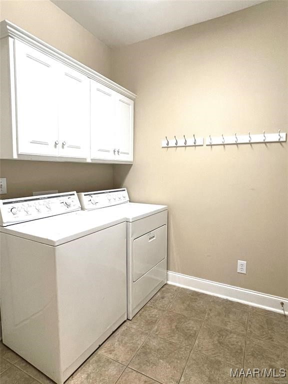 washroom featuring tile patterned flooring, cabinets, and separate washer and dryer