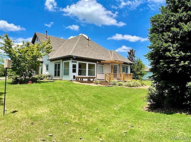 rear view of property with a yard and a deck