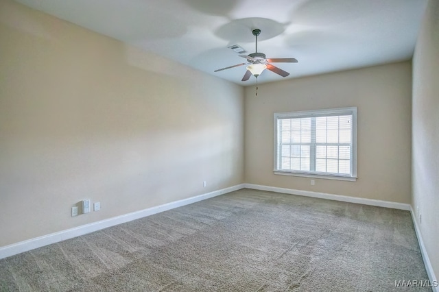 carpeted spare room featuring ceiling fan