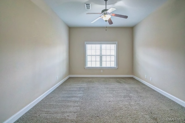 spare room featuring ceiling fan and light colored carpet